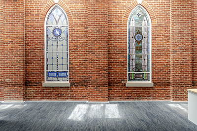 Interior view of original brick building enclosed by the new addition